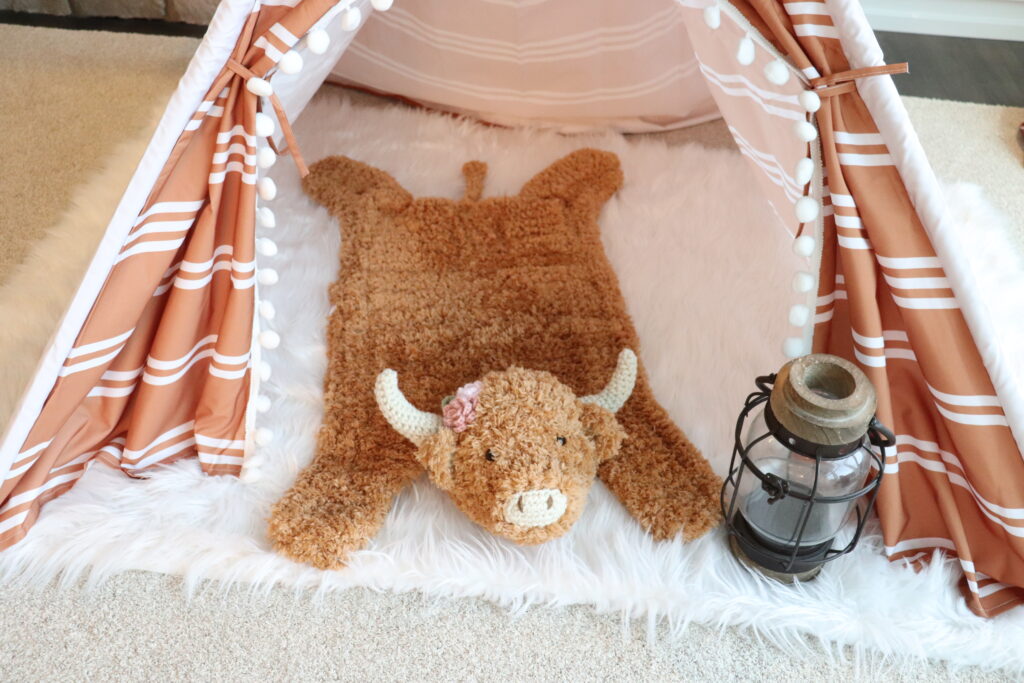 Brown Faux Fur Highland Cow Rug under tent