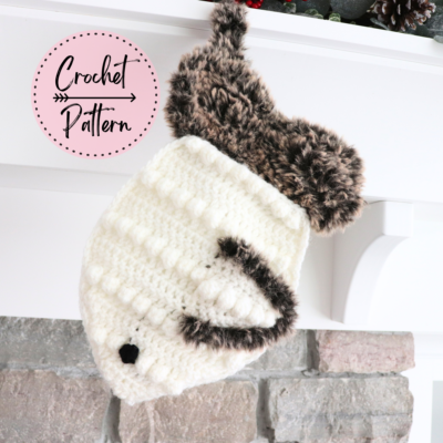 crochet small cat stocking hanging off of mantel