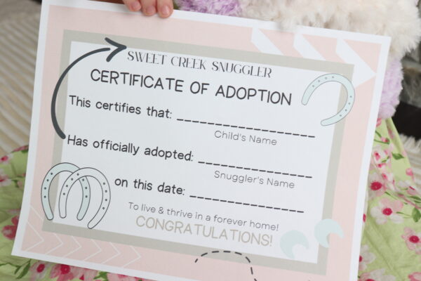 Unicorn Adoption Certificate being held by a little girl