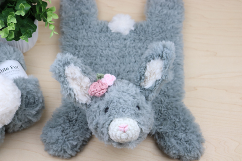 Faux Fur Amigurumi Easter Bunny lying on it's stomach, and showing its cute fluffy rabbit tail