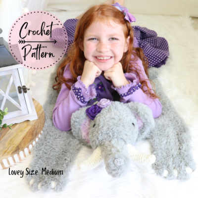 girl laying on medium crochet elephant