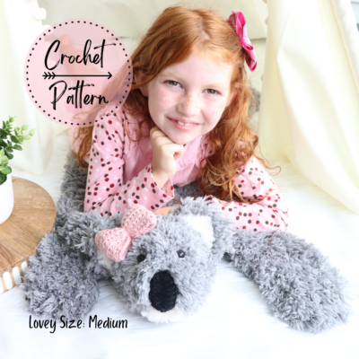girl laying on medium crochet koala bear