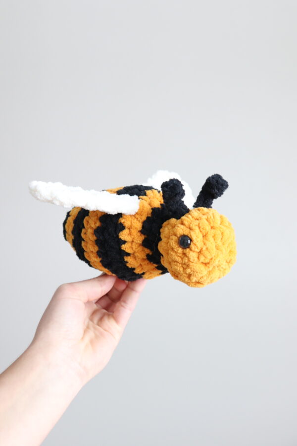 Crochet pattern designer holding crochet bee